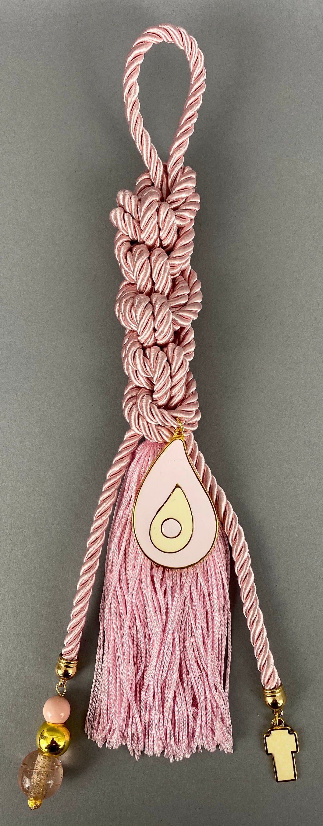 Gouri 1004 Pearl Baby Pink Cord Gouri, large metal Mati, Metal Cross pendant, large murano glass beads and extra long Tassel.  Measures 13.5” in length.