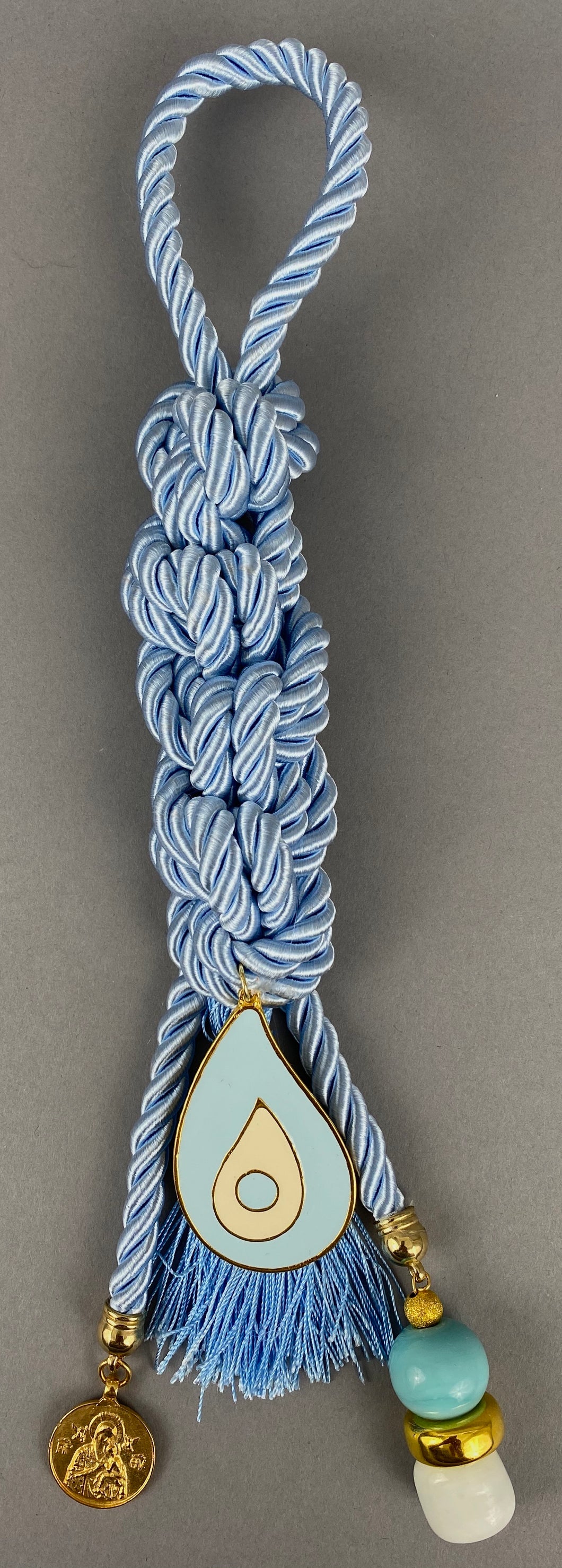 Pearl Baby Blue Cord Gouri, large metal Mati, double sided  Panagia, Ag. Christoforos pendant, large beads and blue Tassel.  Measures 13.5” in length.